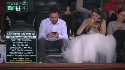 They had a morning wedding so they could make it to the game. She actually turned him into a hockey fan :)