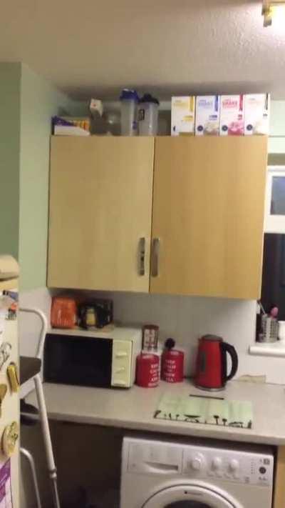 Ghost opens kitchen cupboard
