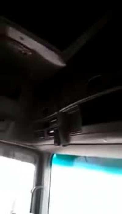 a little girl driving a truck in the highway while her father record her. (Egypt)