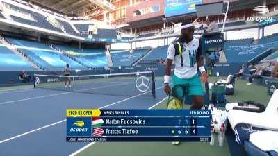 Fucsovics around the net shot and Tiafoe's reaction
