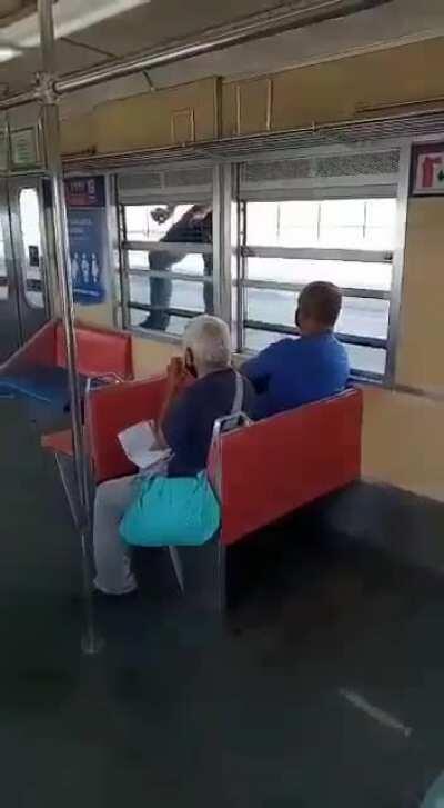 dude holding himself by the train window