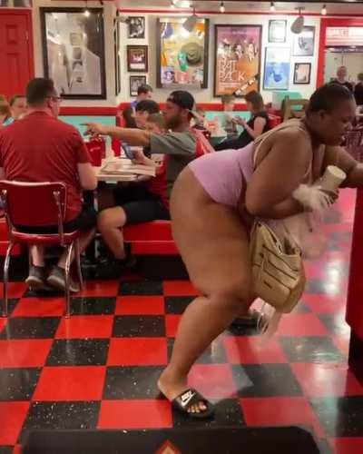 Woman twerks in front of family at restaurant
