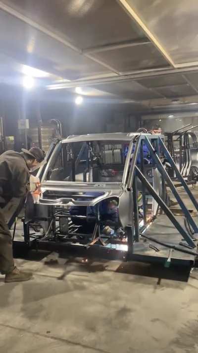 Assembling car body panels (without robots)