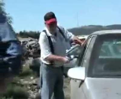 News guy is trying to show the viewers how quick and easy it is for thieves to break into your vehicle and steal your belongings using just a hammer