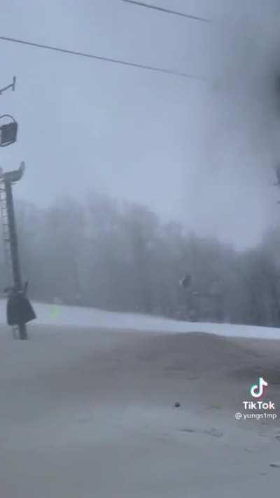 Pipe bursts spraying on woman in broken ski lift in freezing temperatures.