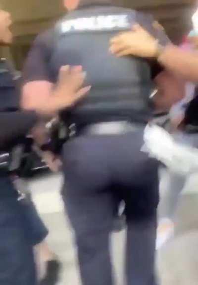 Cop antagonizes and shoves protestors before being removed and then later suspended.