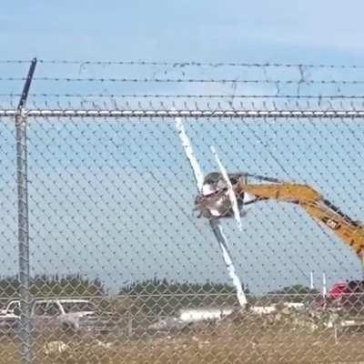 Excavator operator is having fun on a scrapyard
