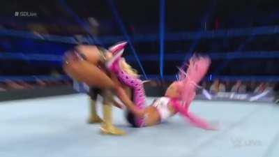 Charlotte chokes poor Liv Morgan out on the ropes and makes her tap out with the figure 8