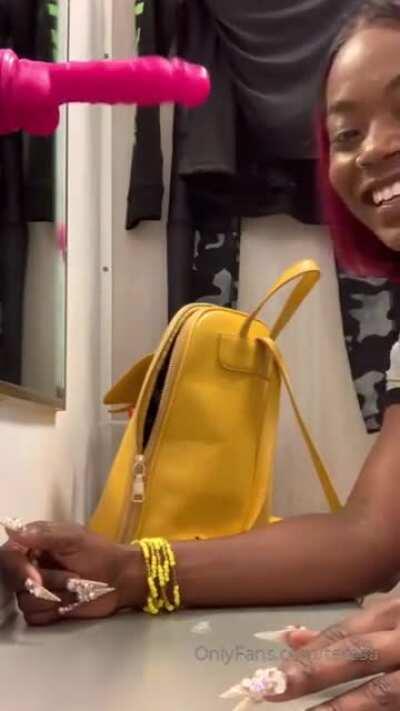 Her mouth's showing that dildo love in a changing room