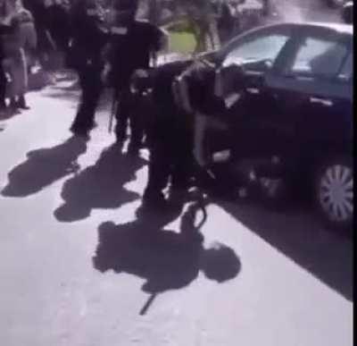 Protester helps drag police officer to ambulance after violent protester knocks him out.