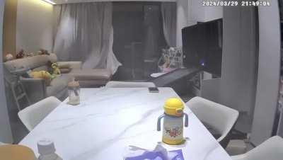 Strong winds in China's Guangdong blew off a balcony door.