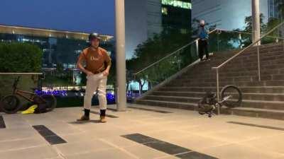 Grinding down a handrail on a BMX bike