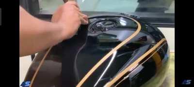 RE India employees drawing perfect design on fuel tanks