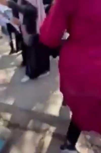 Taliban terrorist randomly assaulting female protesters with a whip