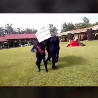 Guys dance while holding a coffin