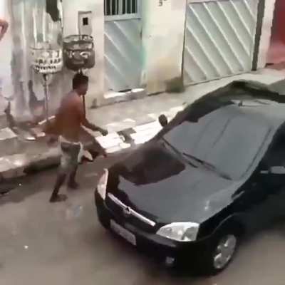 Punching the hood of a car while wondering in the street