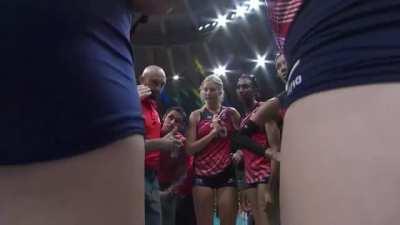 Cameraman trying to get a good shot of the huddle