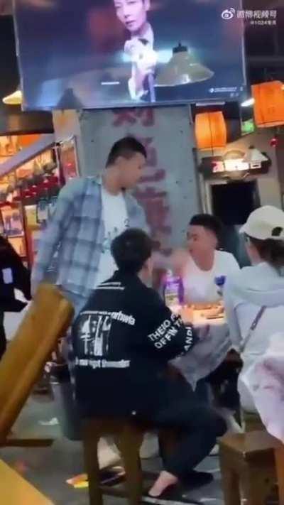 Guy aggessively grabs another guy's arm, then and gets smashed.