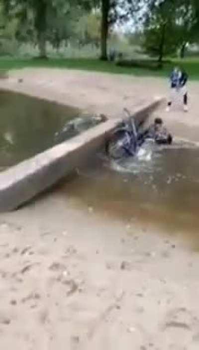 WCGW crossing a narrow bridge on a bike
