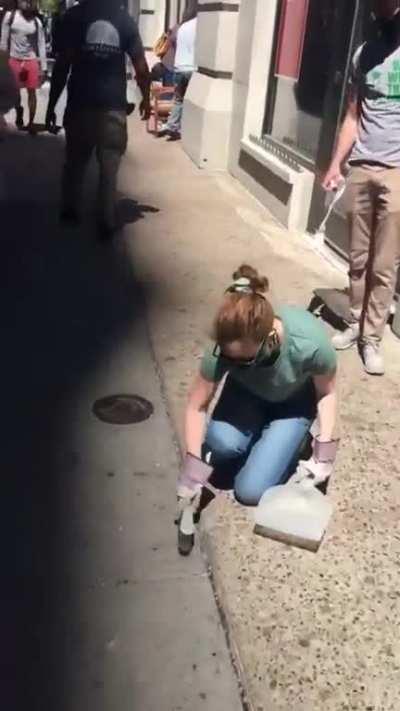 Protestors helping to clean up the riots