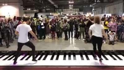 Pirates of the Caribean Theme played on a piano mat by a team of incredible dancers