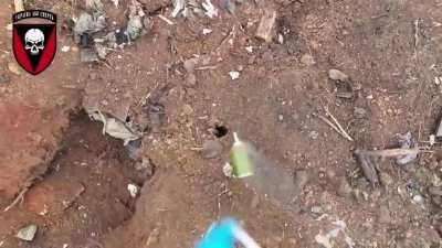 A drone of the 72nd Mechanized Brigade dropping a grenade through a small hole in a Russian trench dugout. In the east.