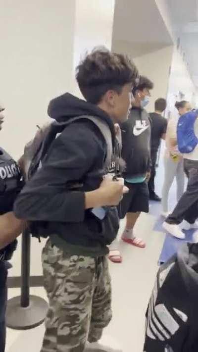 Massive crowd surrounding 2 students fighting. (Accidental slam?)