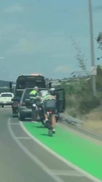 Cyclist somehow hits a parked police motorbike with lights on