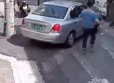 A passing woman jumps in to help a man whose runaway car was stuck in reverse