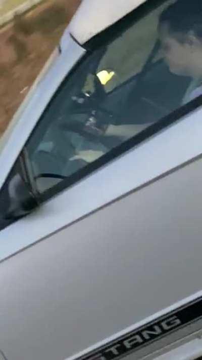 Watching tv while picking her nose while driving on the freeway