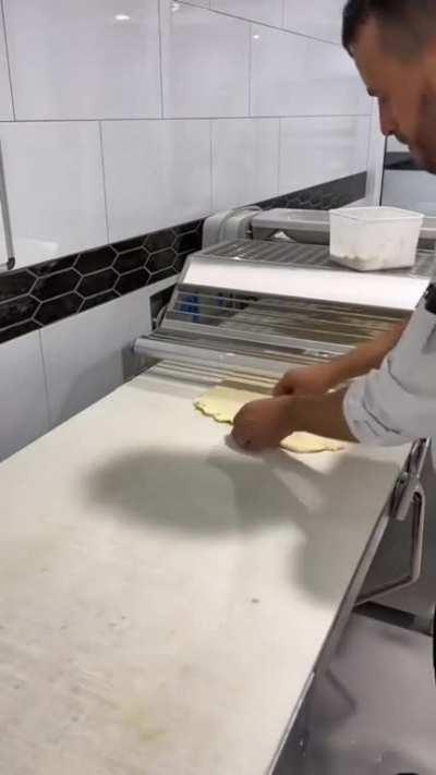 Baker making croissants