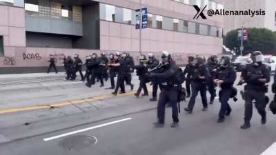 LAPD in full riot gear has arrived to back up DHS agents trapped inside a federal government parking structure.