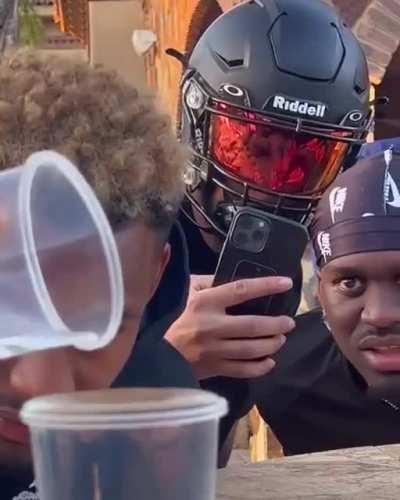 Bunch of guys try to pour water into a cup, the person to make it overflow gets dunked into a pool