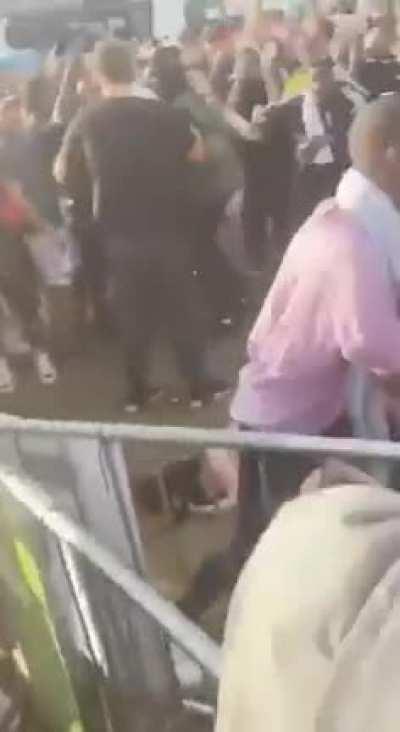 Festival security hands a girl a shlap during an altercation