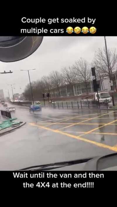 Couple getting soaked by multiple cars
