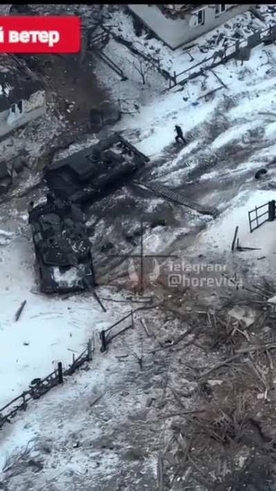UA POV Ukrainian drone observes Russian troops turning a disabled T-90M around with a recovery vehicle to tow it away. It seemingly hit a mine and lost its track. A pair of other tanks burn nearby. February video.