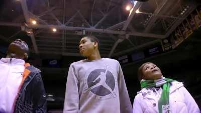 Giannis in 2013, showing his parents the Bucks jerseys in the rafters; hopes maybe one day his number will be up there.