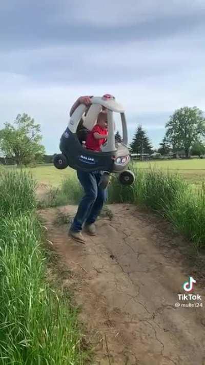 Father of the year helps his kid get some sick air
