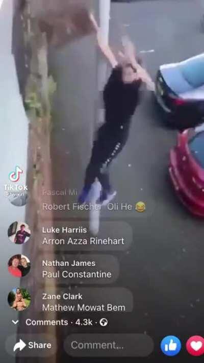 Man climbs stone wall as it breaks a piece and lands on his leg