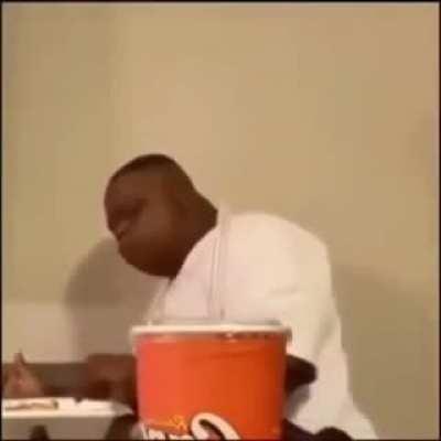 Black man falls off chair