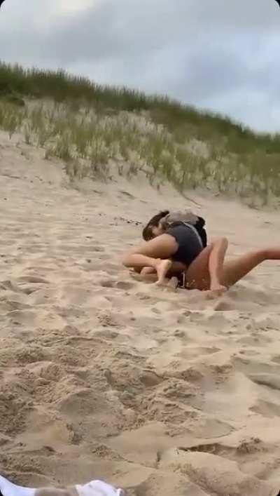 Lily Chee wrestling on the beach