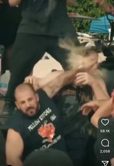 Standing next to a mosh pit with a beer