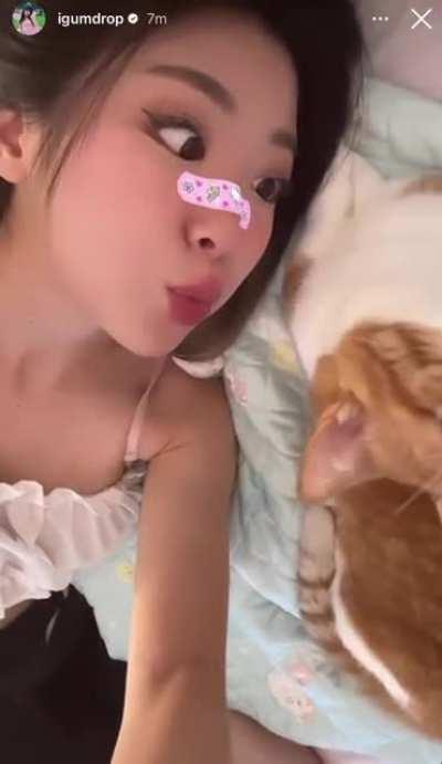 Jaime looking cute laying in bed trying to kiss her kitty