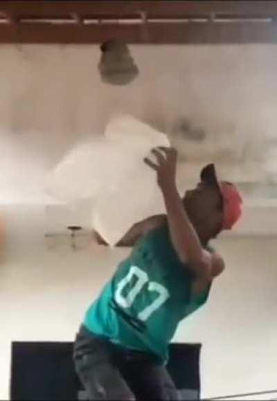 Trying to remove a wasp nest with a plastic bag.