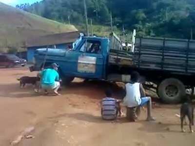 Imbecile backs truck off cliff trying to dislodge it from being stuck in mud