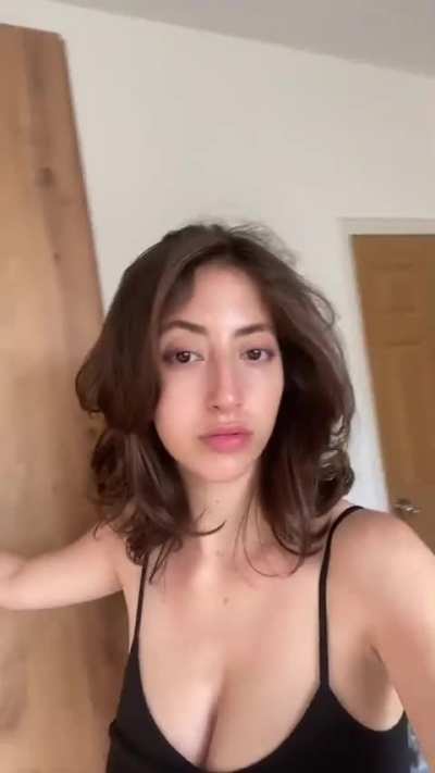 Holding up her own tits