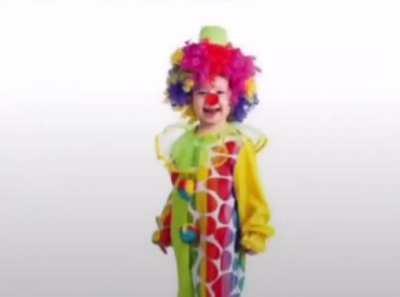 A guy taking a photo of a kid in a clown costume.