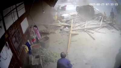 Old lady and cat narrowly escape boulder coming through their house.