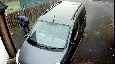 Criminal throws brick at the car