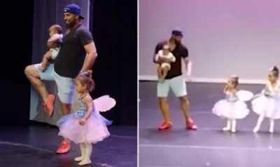Dad clutching a baby runs onto stage to hold his ballet dancing daughter's hand after she suffers stage fright... and becomes the star of the show